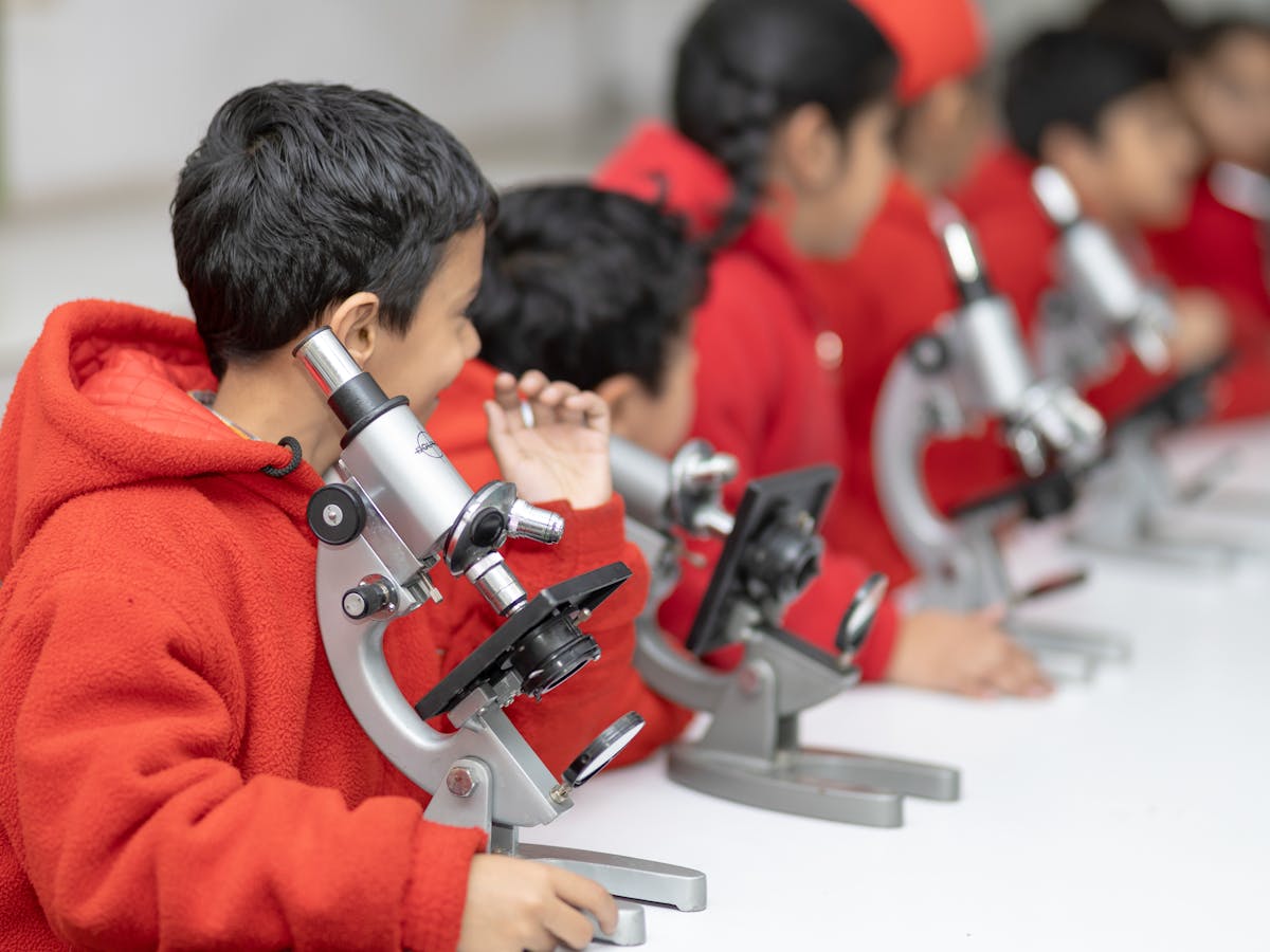 Indian students using microscopes in a school science laboratory